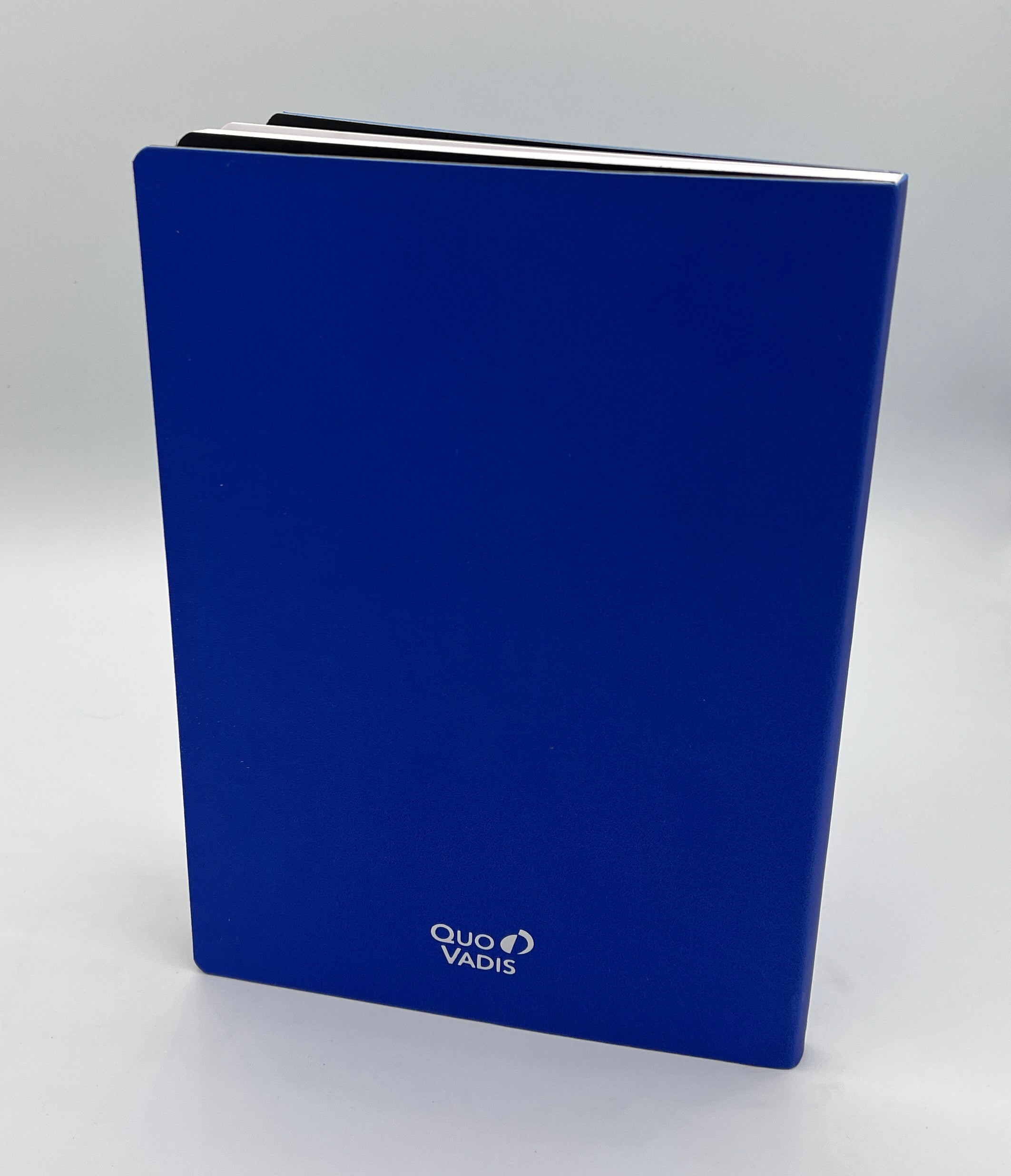 Blue notebook with 'Quo Vadis' branding on a white background