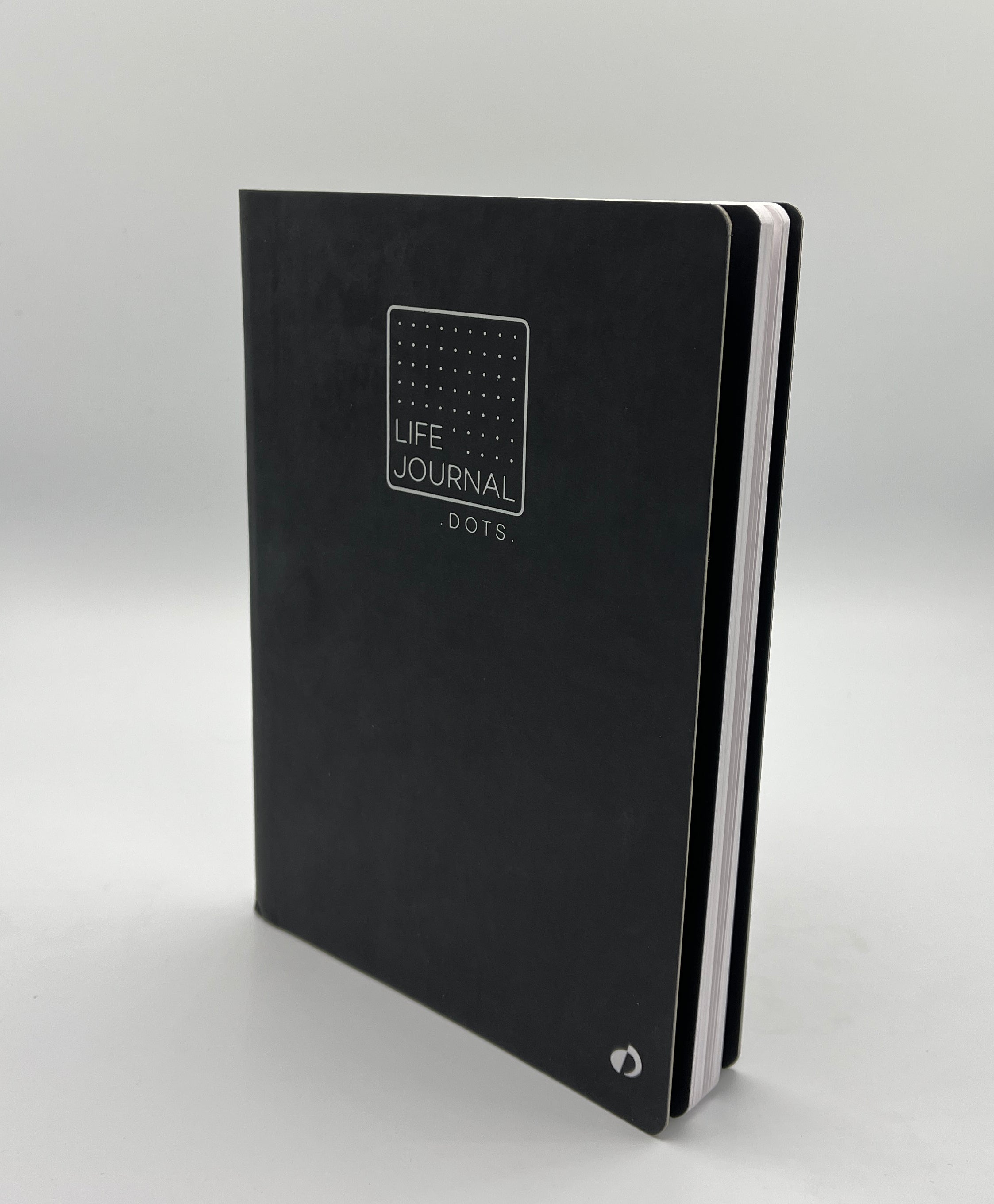 Black journal with 'Life Journal Dots' text on a light gray background