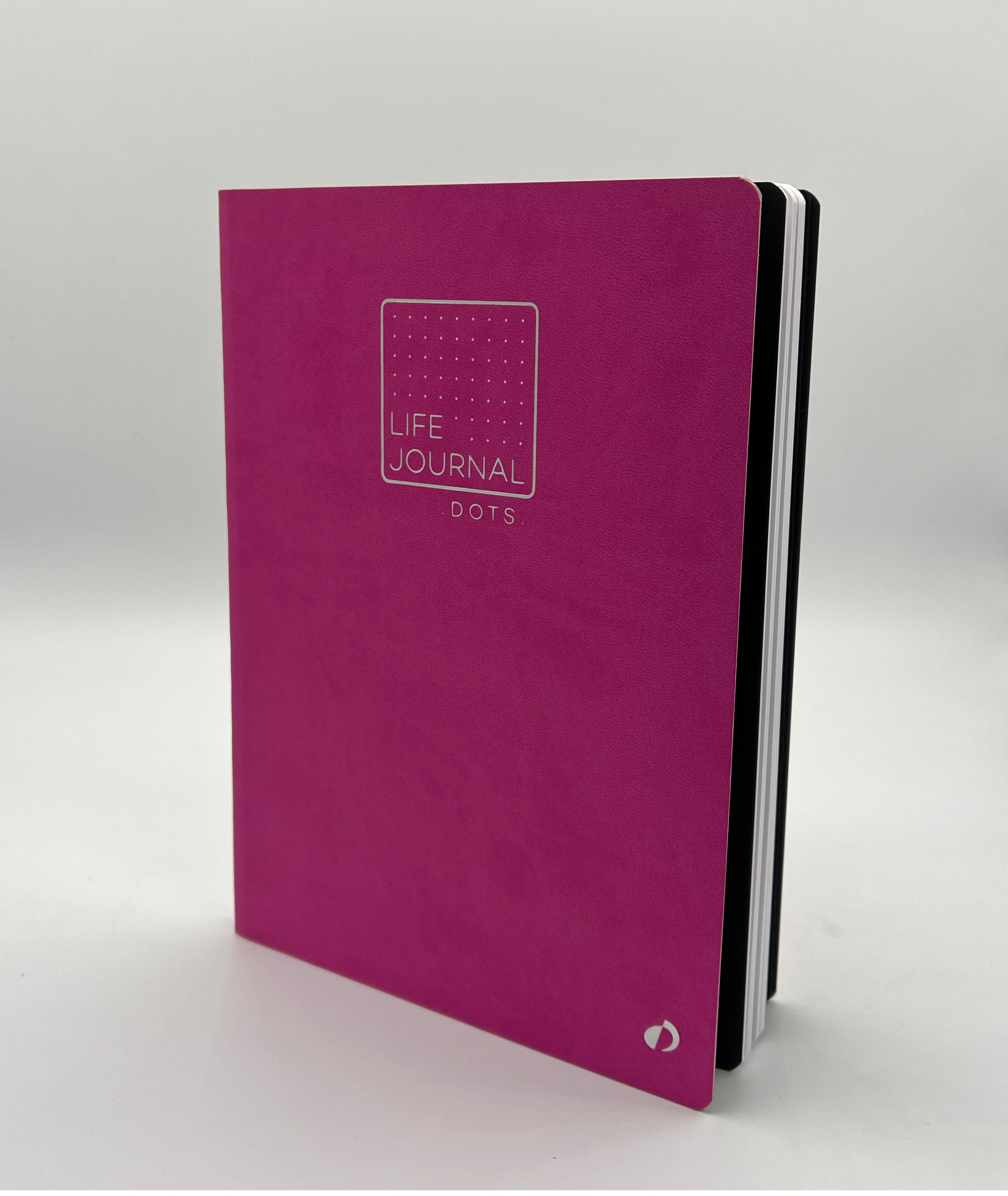 Pink journal with 'Life Journal Dots' text on a white background