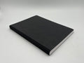 Black notebook on a light gray background