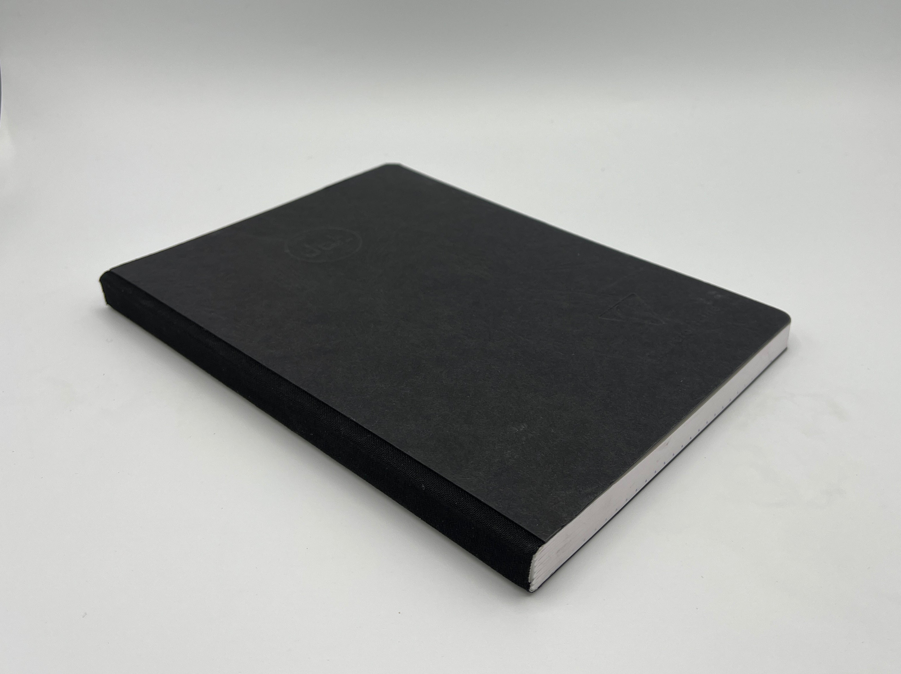 Black notebook on a light gray background