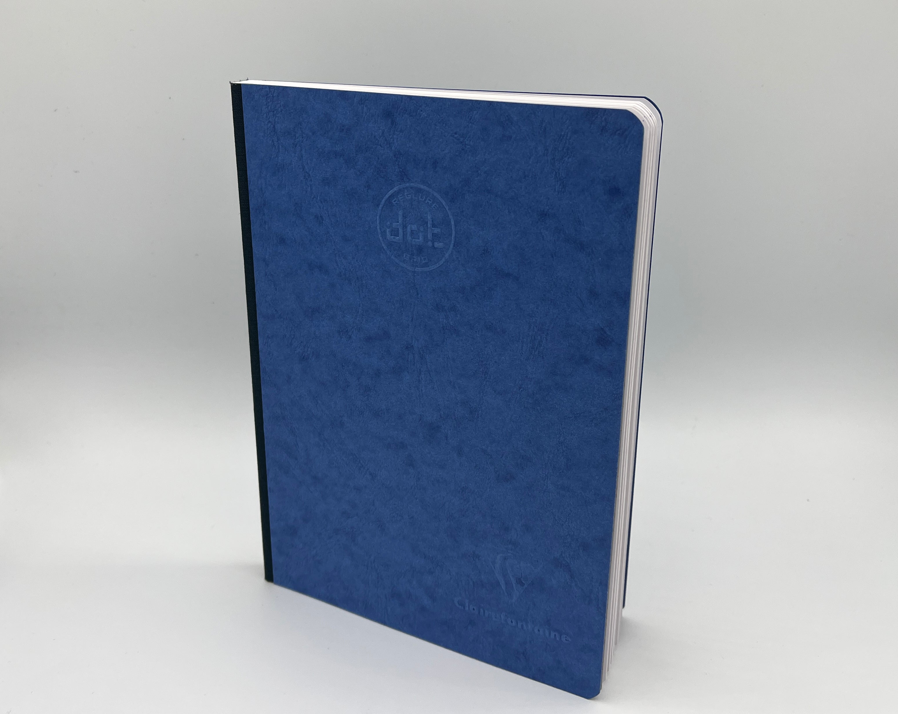 Blue notebook with a logo on a gray background