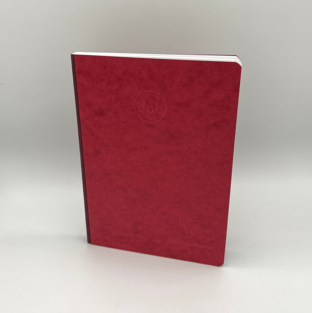 Red notebook with a logo on a white background