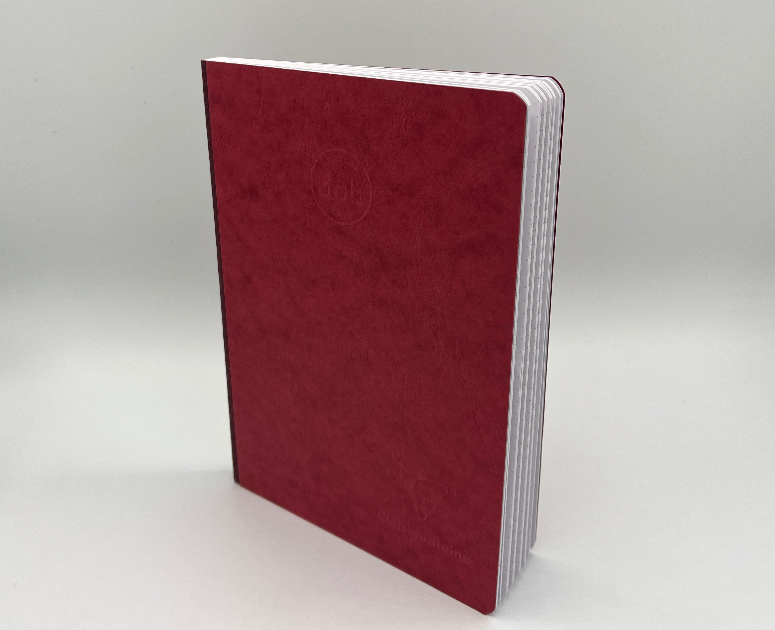 Maroon notebook on a light gray background