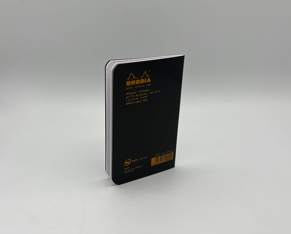 Black notebook with Rhodia logo on a gray background