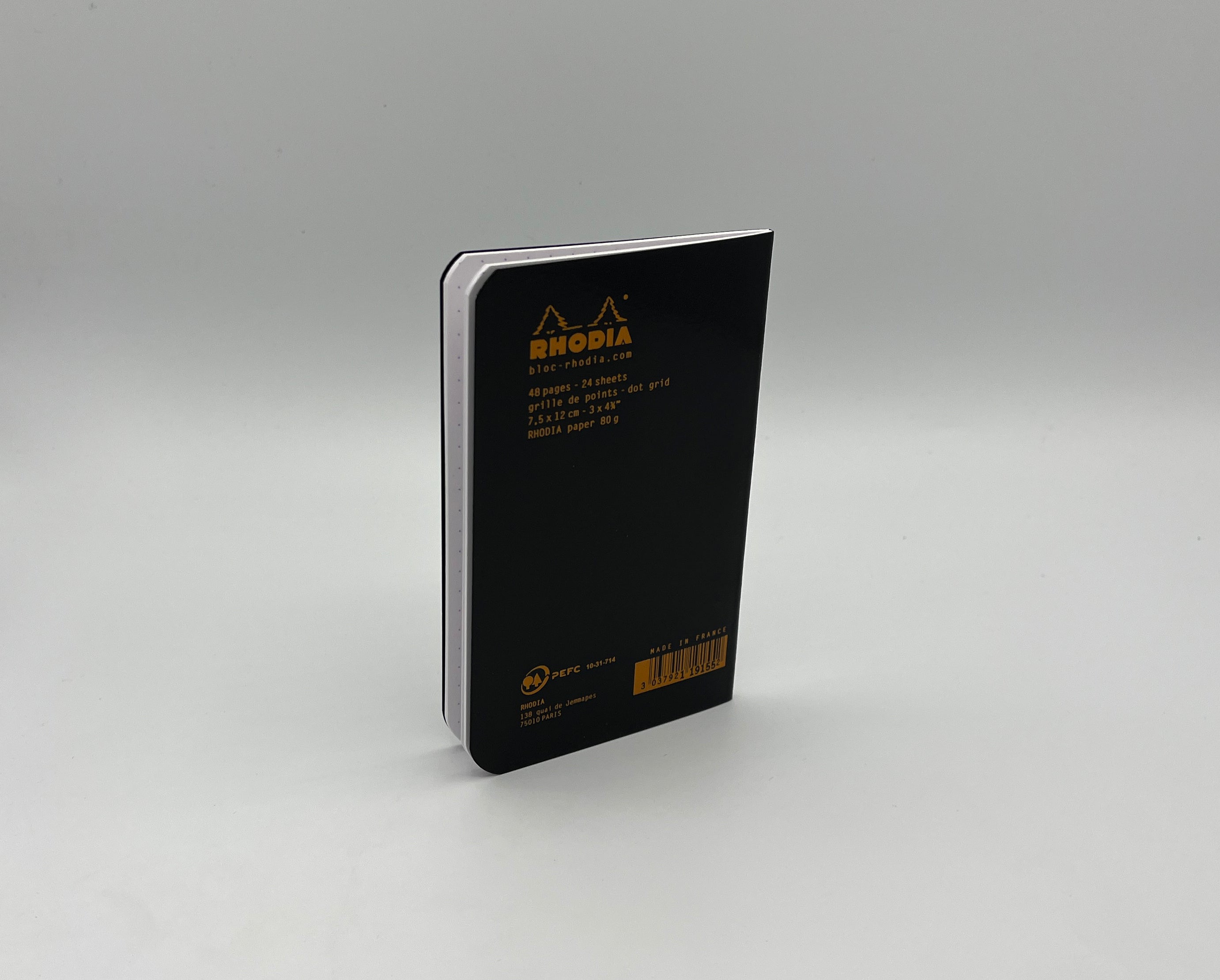 Black notebook with Rhodia logo on a gray background