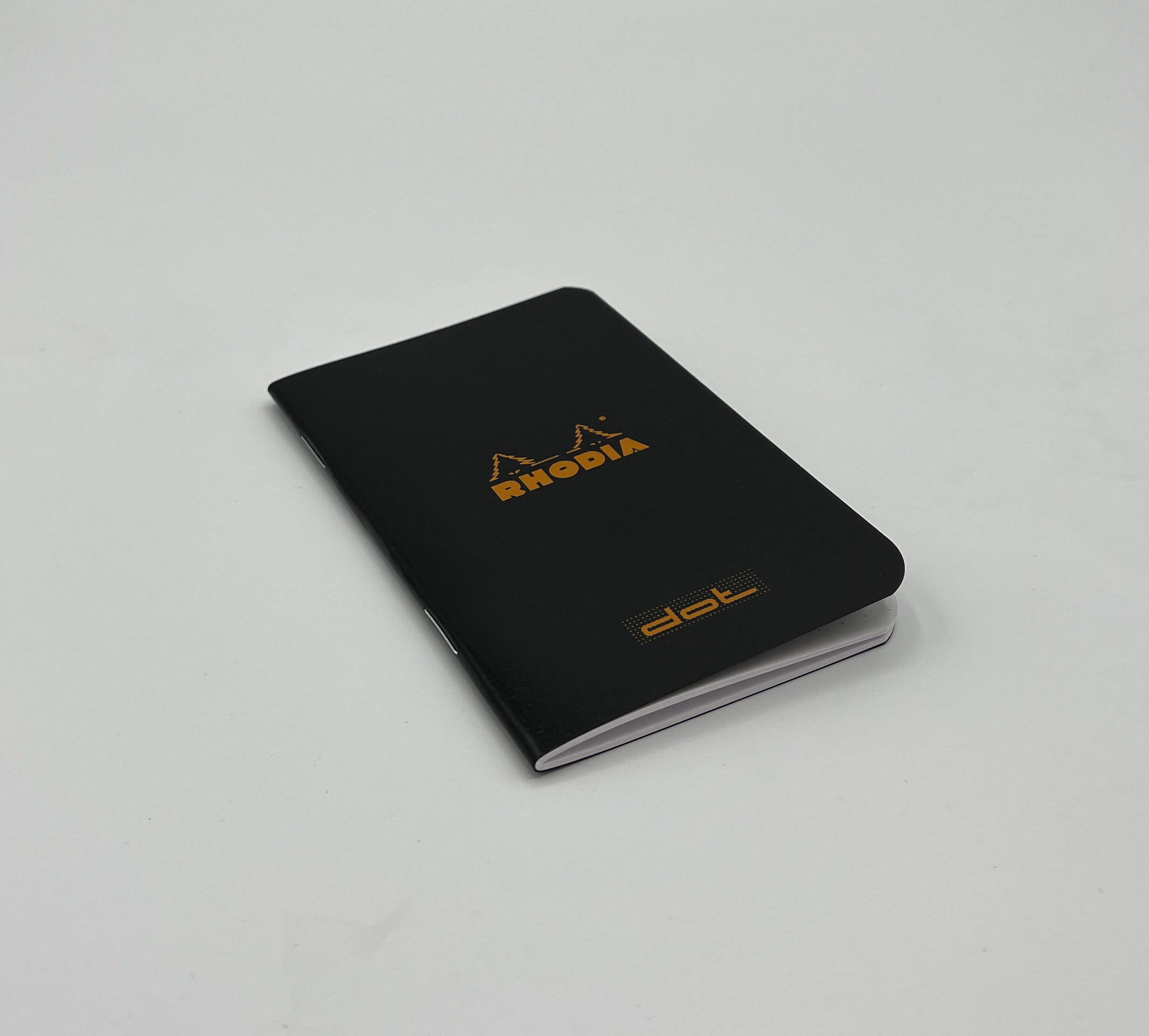 Black notebook with Rhodia logo on a gray background