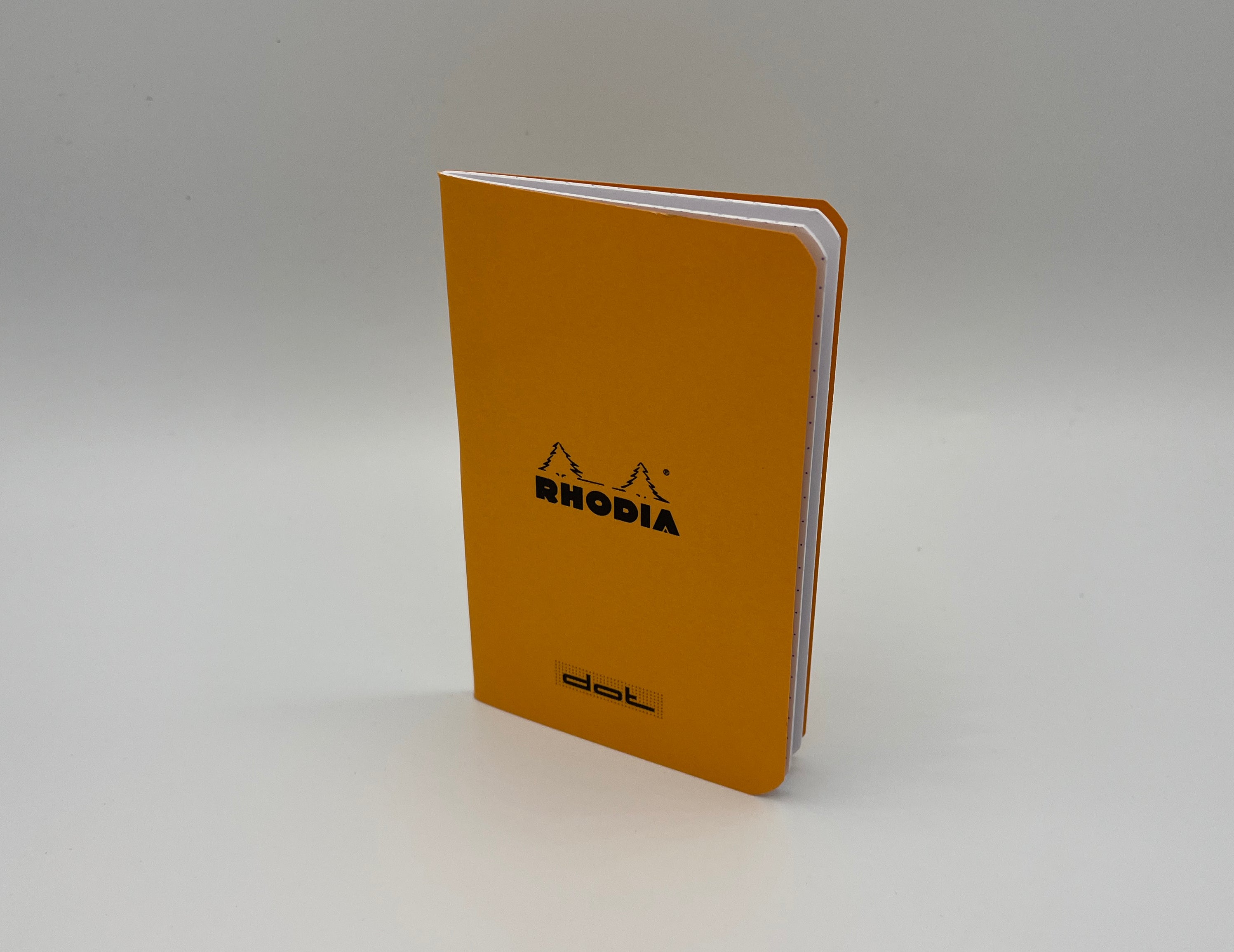 Yellow Rhodia notebook on a white background