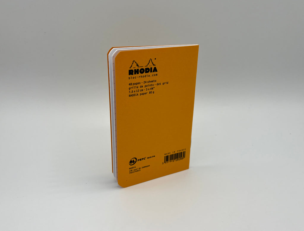 Yellow notebook with Rhodia branding on a gray background