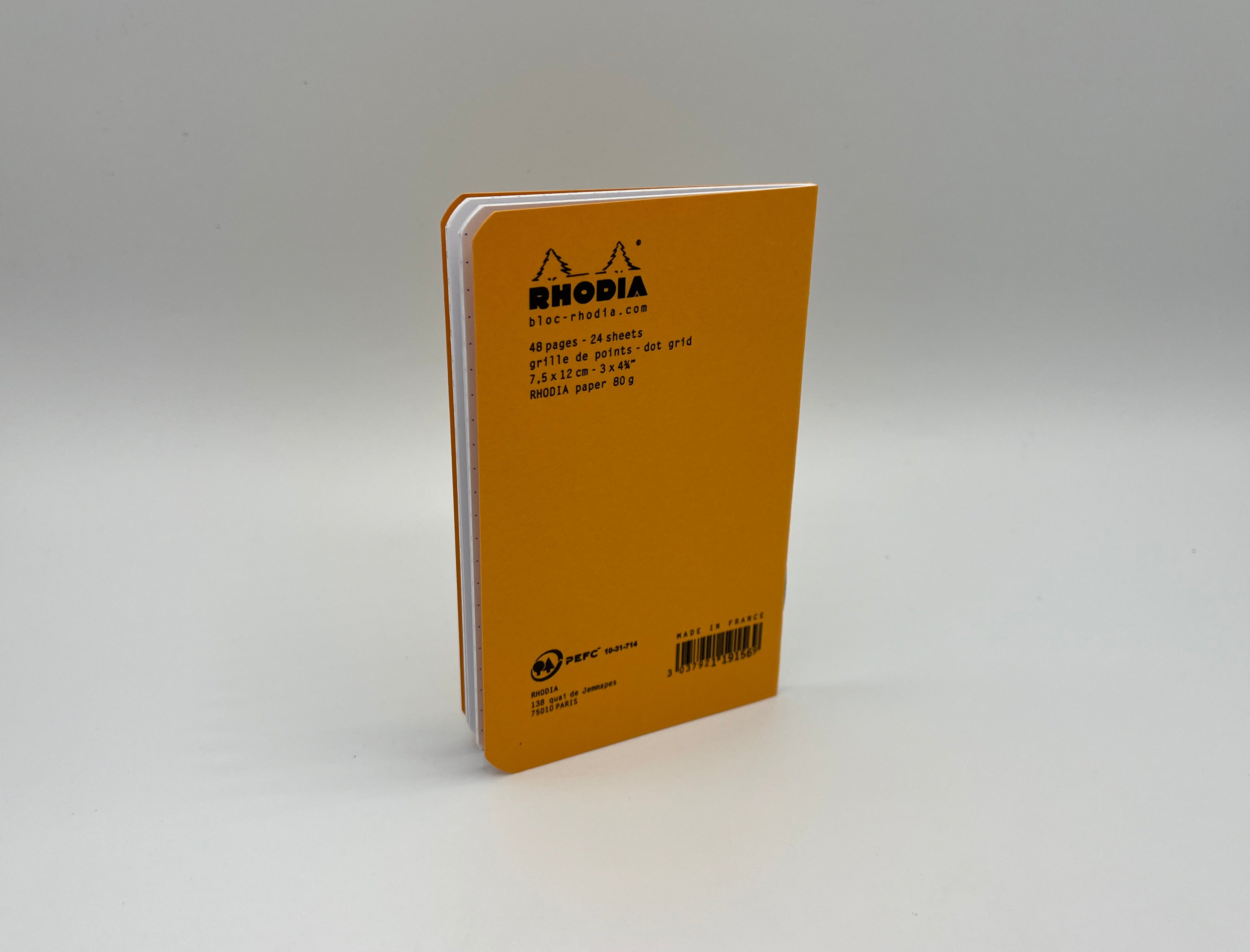 Yellow notebook with Rhodia branding on a gray background
