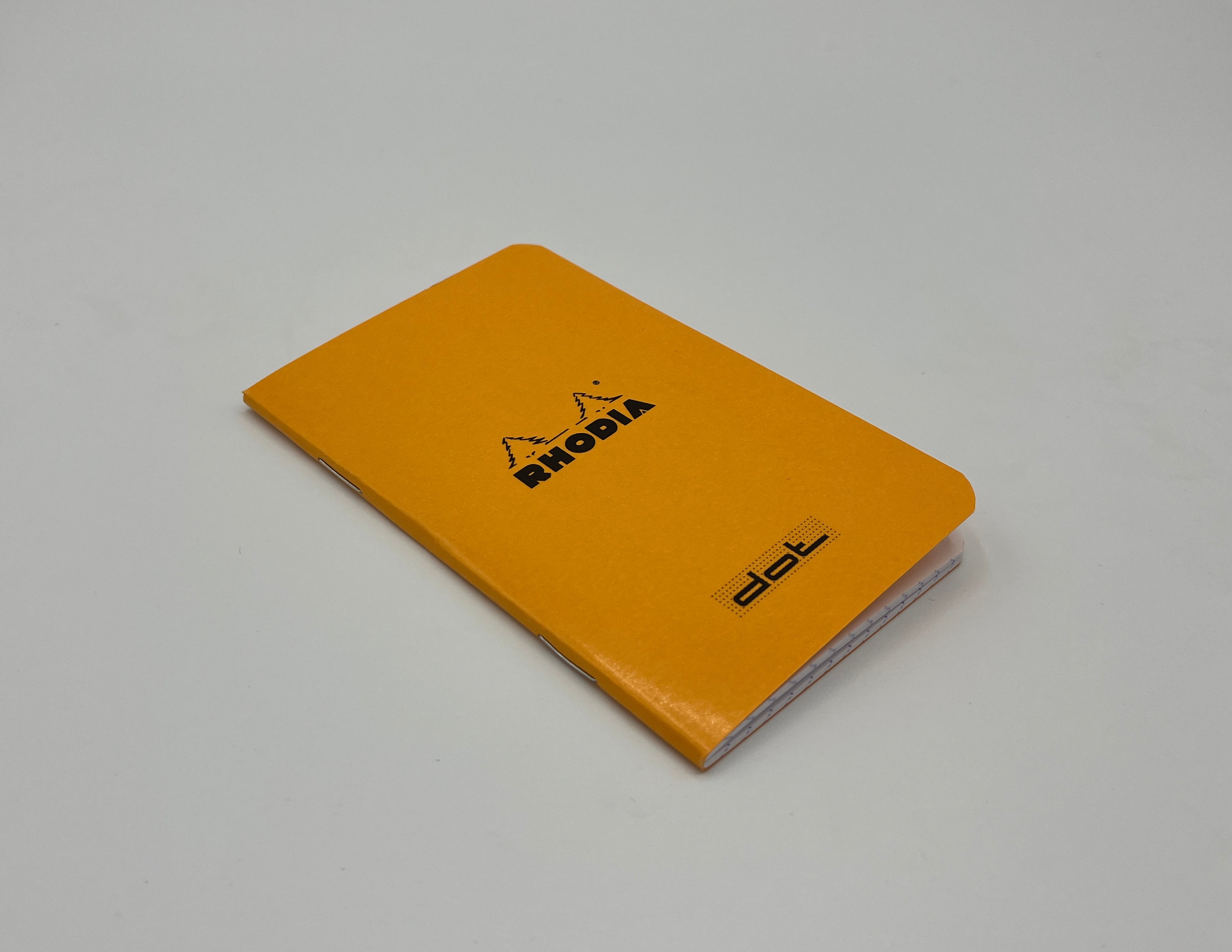 Orange notebook with Rhodia logo on a gray background