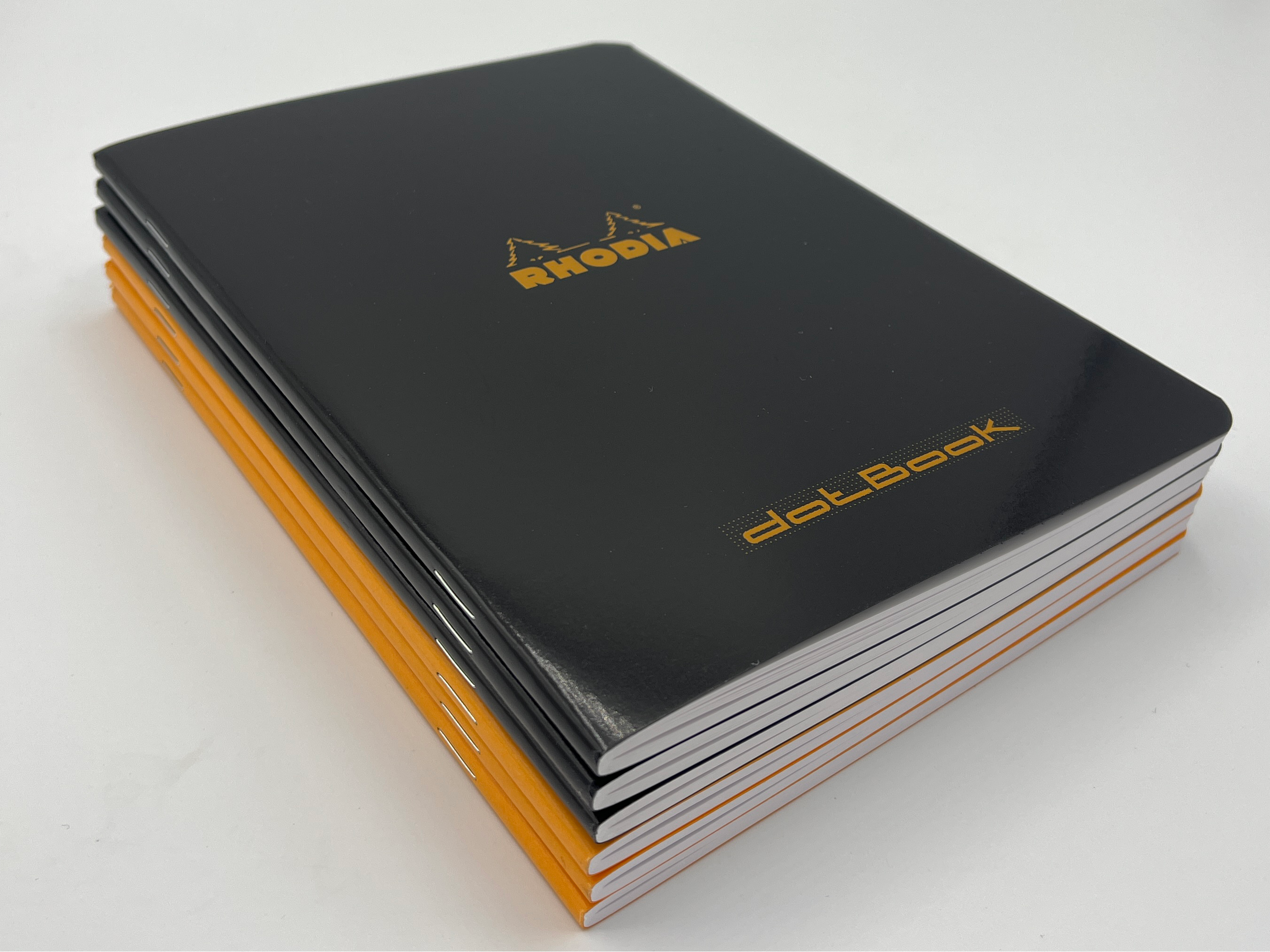 Stack of Rhodia notebooks on a white background